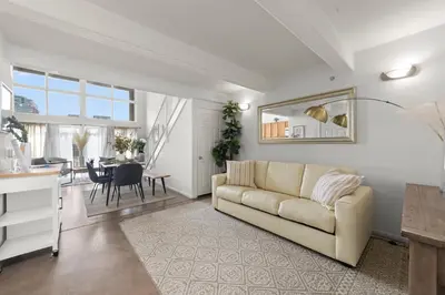 a living room with a couch and a table at The Italian Retreat, Little Italy in San Diego