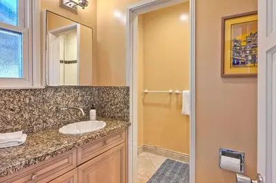 a bathroom with a sink and a mirror at Villa Jules, Oceanfront, Private Beach, Fire Pit in Oceanside