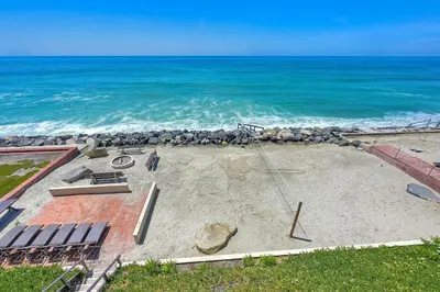 a sandy beach with the ocean in the background at Villa Jules, Oceanfront, Private Beach, Fire Pit in Oceanside