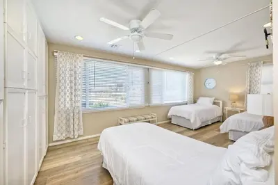 a bedroom with two beds and a ceiling fan at Villa Jules, Oceanfront, Private Beach, Fire Pit in Oceanside