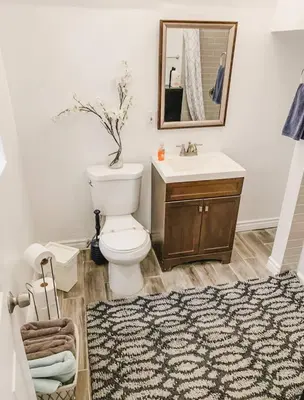 a bathroom with a toilet and a sink and a rug at Convention close by 2BR Suite Free Parking in San Diego