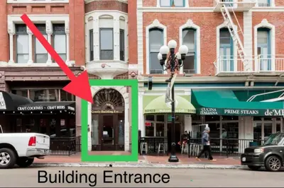 a building entrance on a city street with a red arrow at Free Parking Loft Suite Walk to Conv Center in San Diego