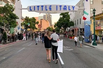 a man and a woman walking down a street at 2BR Free Parking Walk to Convention Center in San Diego