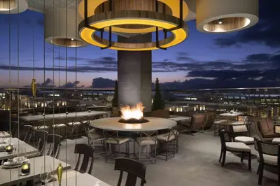 a restaurant with tables and chairs and a fire pit at Loft Suite Walk to Conv Center Free Parking in San Diego