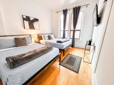 a bedroom with two beds and a couch at Walk to Conv Center 2BR Top Floor Parking Incl in San Diego