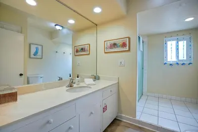a bathroom with a sink and a large mirror at Oceanfront 4BR, Private Beach & Patio, Remodeled Kitchen in Oceanside