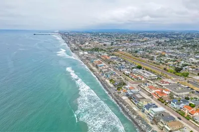 an aerial view of a beach and the ocean at Oceanfront 4BR, Private Beach & Patio, Remodeled Kitchen in Oceanside