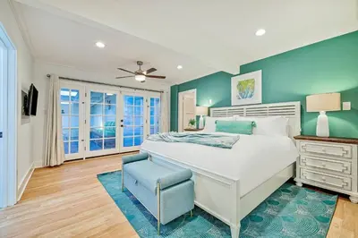 a bedroom with a white bed and a blue wall at 1185 Tamarack home in Carlsbad