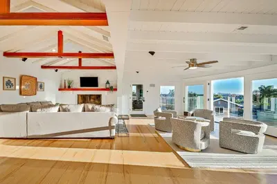 a living room with white furniture and a ceiling fan at 1185 Tamarack home in Carlsbad