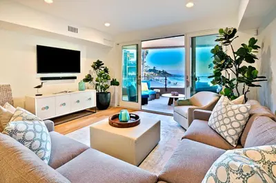 a living room with two couches and a television at Stunning Oceanfront Getaway at Windansea Beach in San Diego