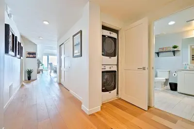 a hallway with a washer and dryer in a house at Stunning Oceanfront Getaway at Windansea Beach in San Diego