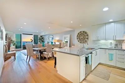 a kitchen and dining room with a table and a dining room at Stunning Oceanfront Getaway at Windansea Beach in San Diego