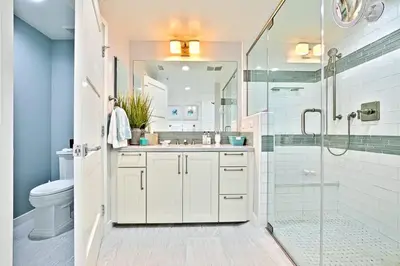 a bathroom with a shower and a sink and a toilet at Stunning Oceanfront Getaway at Windansea Beach in San Diego