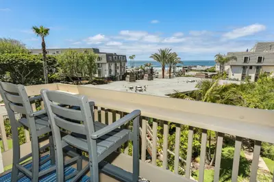 a balcony with two chairs and a view of the ocean at B205 - Ocean Escape in Oceanside