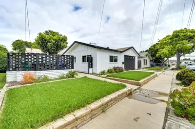 a white house with a yard with green grass at Pet-Friendly San Diego Studio about 14 Mi to Downtown in San Diego