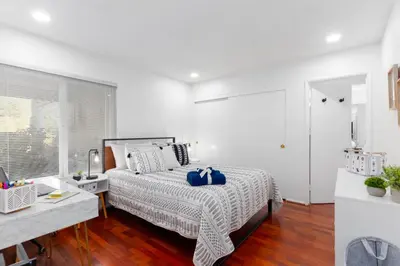 a bedroom with a bed with blue pillows on it at Vacation Oasis! Ocean Views~Mini Golf~King-Suites in Solana Beach