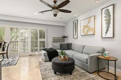 a living room with a couch and a ceiling fan at 683 Just inside the gates of the Resort - Golf & Premier Fitness Guests Welcome in Encinitas