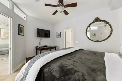 a bedroom with a bed and a ceiling fan at 683 Just inside the gates of the Resort - Golf & Premier Fitness Guests Welcome in Encinitas