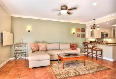 a living room with a couch and a table at 604 Gorgeous Renovated Condo, Steps to Omni Spa, Golf, Tennis, PFC & Exclusive Building Pool in Encinitas
