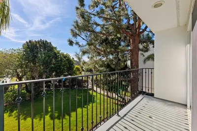 a balcony with a fence and a tree at 628 Escape to Relaxation-Free Wifi-Free Parking in Encinitas