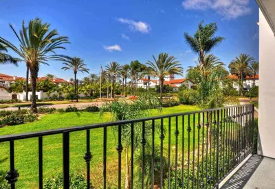 a balcony with a view of a park with palm trees at 629 Walk to Restaurants Close to Golf and Spa Luxury Inside the gates in Encinitas
