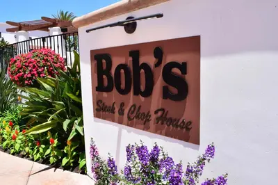 a sign on the side of a building with flowers at 629 Walk to Restaurants Close to Golf and Spa Luxury Inside the gates in Encinitas