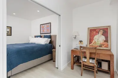 a bedroom with a bed and a desk with a painting at 644 A Renovated Condo at a World-Renowned Resort - Free Wifi and Parking in Encinitas