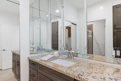 a bathroom with a sink and a large mirror at 644 A Renovated Condo at a World-Renowned Resort - Free Wifi and Parking in Encinitas