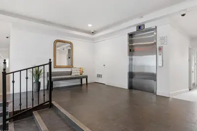 a hallway with a metal elevator and a mirror at 644 A Renovated Condo at a World-Renowned Resort - Free Wifi and Parking in Encinitas