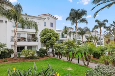 a building with palm trees in front of it at 644 A Renovated Condo at a World-Renowned Resort - Free Wifi and Parking in Encinitas