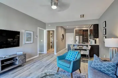 a living room with a blue chair and a couch at 647 Luxury Inside The Gates LaCosta Resort-Top Floor Steps from Resort 647 in Encinitas