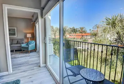 a balcony with a chair and a table and a couch at 647 Luxury Inside The Gates LaCosta Resort-Top Floor Steps from Resort 647 in Encinitas