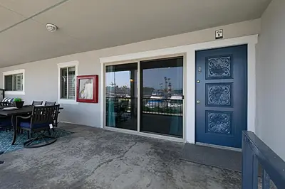 a dining room with a table and a large window at 106B New Renovation! Huge Patio with Harbor View in Oceanside
