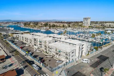 an aerial view of a marina with buildings and boats at 106B New Renovation! Huge Patio with Harbor View in Oceanside