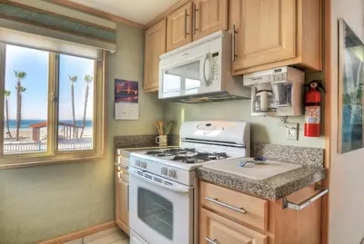 a kitchen with a stove and a view of the ocean at 210A Marina Del Mar - Beach View in Oceanside