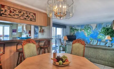 a kitchen and living room with a table with a bowl of fruit at 210A Marina Del Mar - Beach View in Oceanside
