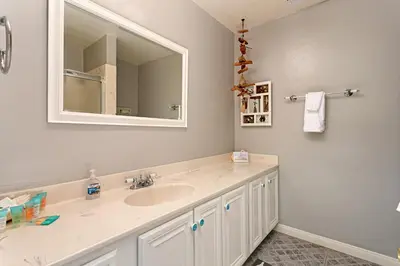 a bathroom with a sink and a mirror at 210B Harbor Views Short Stroll to Beach, Large Balcony, Walk to Dining Shops in Oceanside