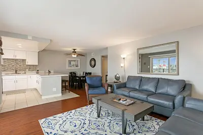 a living room with a couch and a table at 210B Harbor Views Short Stroll to Beach, Large Balcony, Walk to Dining Shops in Oceanside