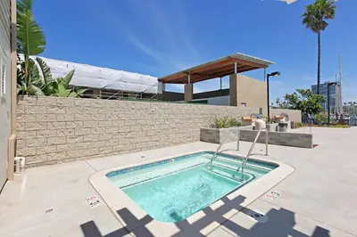 a swimming pool in front of a building at 211B - Harbor, Seals, Birds, Night Lights, Steps to the Sand! in Oceanside