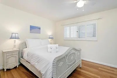 a white bedroom with a bed and a window at 212A Beachfront View-Free Wifi in Oceanside