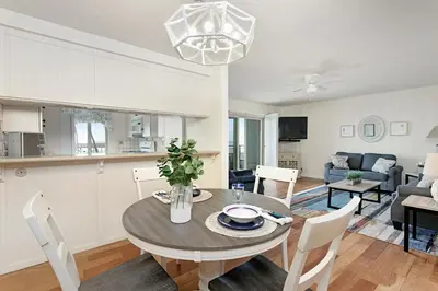 a dining room and living room with a table and chairs at 212A Beachfront View-Free Wifi in Oceanside