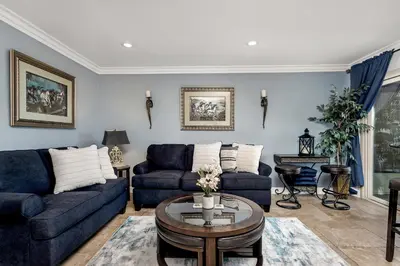 a living room with blue couches and a table at 213A - Take a Beach Break at Marina Del Mar - Beach & Ocean Views in Oceanside
