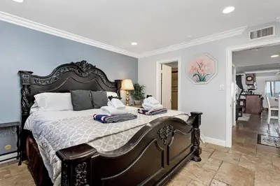 a bedroom with a large bed with two towels on it at 213A - Take a Beach Break at Marina Del Mar - Beach & Ocean Views in Oceanside