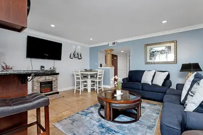 a living room with a couch and a table at 213A - Take a Beach Break at Marina Del Mar - Beach & Ocean Views in Oceanside