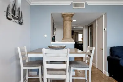 a kitchen and dining room with a table and chairs at 213A - Take a Beach Break at Marina Del Mar - Beach & Ocean Views in Oceanside