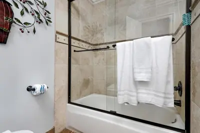 a bathroom with a shower with a glass door at 213A - Take a Beach Break at Marina Del Mar - Beach & Ocean Views in Oceanside