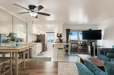a kitchen and a living room with a ceiling fan at 214A - Beach and Water View, Steps to the Sand in Oceanside