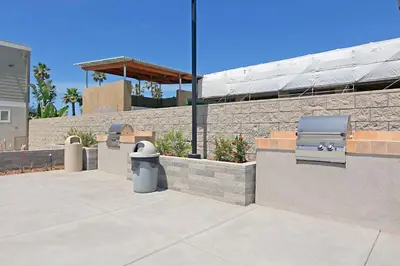 a trash can sitting in front of a brick wall at 301B Ocean Harbor View - Top Floor Corner Unit in Oceanside