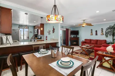 a dining room and living room with a table and chairs at 305B - Seaside at the Marina - 100 Steps to the Sand in Oceanside