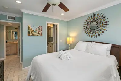 a bedroom with a large bed with towels on it at 305B - Seaside at the Marina - 100 Steps to the Sand in Oceanside